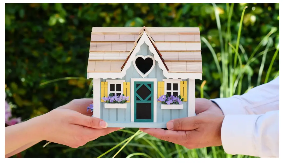Home buyers and sellers exchanging a model house